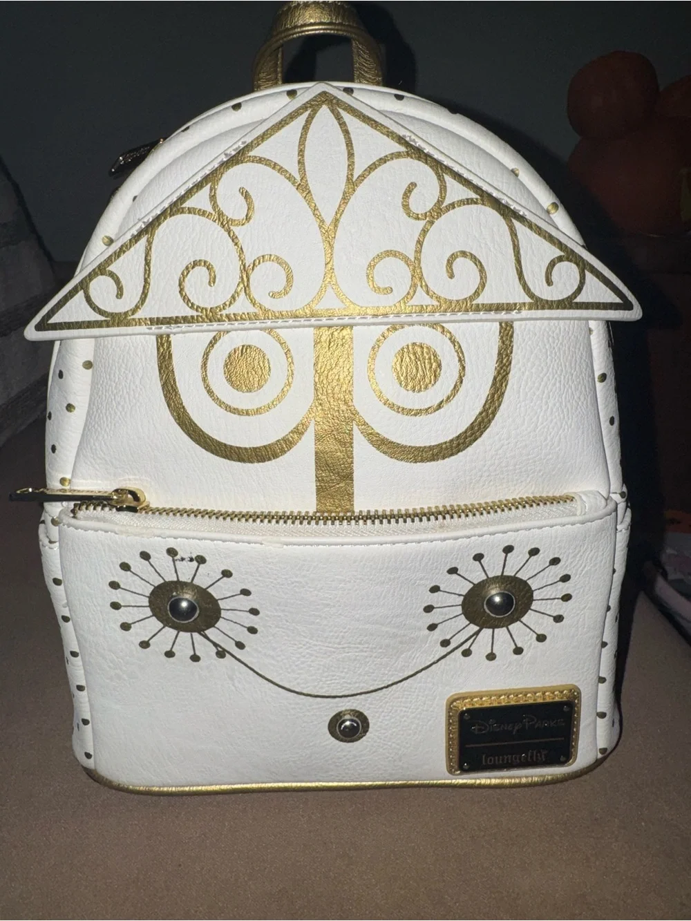 Loungefly White & Gold Mini Backpack with Decorative Face Motif